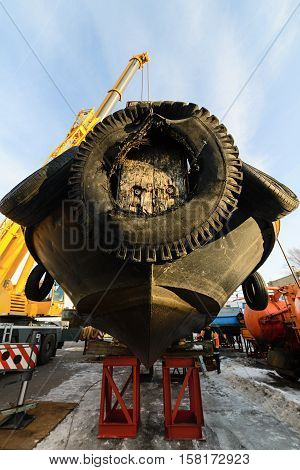MOSCOW, RUSSIA - NOVEMBER 11, 2016: State Unitary Enterprise Mosvodostok performs recovery vessels on coastal winter parking. Ship mounted on metal supports.