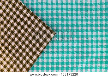 Wooden table covered with tablecloth. View from top. Empty tablecloth for product montage. Free space for products and for your text