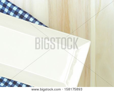 Top view plate on checkered tablecloth pattern background .Free space for products and for your text