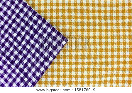 Wooden table covered with tablecloth. View from top. Empty tablecloth for product montage. Free space for products and for your text
