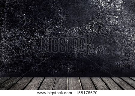 Old wooden table in front of black chalkboard vintage wall. Blackboard with wooden floor for your text.. View with copy space