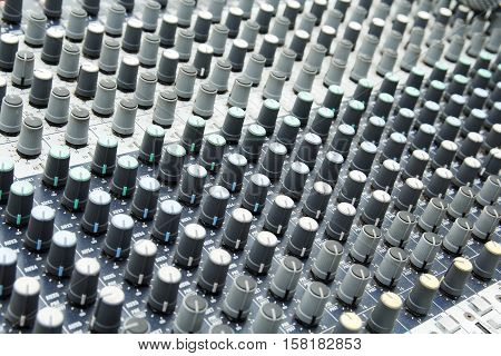 Sound mixer background. Music instruments or dj concept. Musical equipment control console.