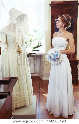 MOSCOW AUGUST 17 2014: russian bride in noble house museum look at bridal vintage dress from 19 th centure in Moscow August 17 2014