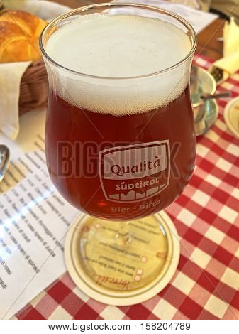 KLAUSEN, ITALY - SEPTEMBER, 2016 : Home brew sweet Chestnut beer during Autumn in Klausen, Italy on September 24, 2016. It is brewed in Gasslbrau, traditional South Tyrolean public house brewery