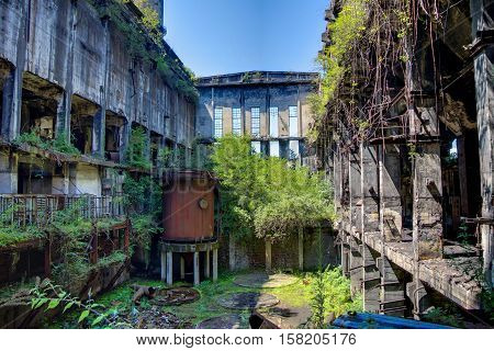 Abandoned, destroyed by war and overgrown machinery of Tkvarcheli power plant, Abkhazia, Georgia