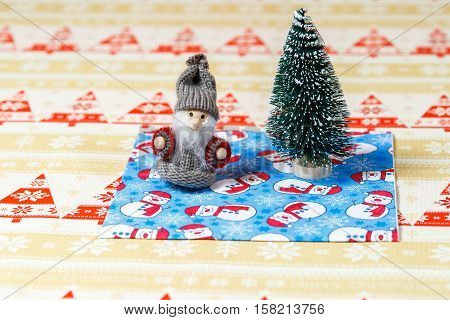 Santa Claus Near Christmas Tree  On Snowman Background