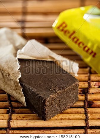 close up of a brick of belacan shrimp paste