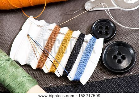 detail of sewing kit on the gray clothing