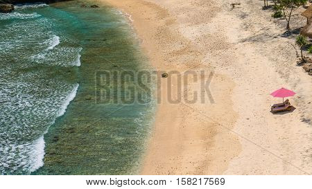 Lila Sunbed on Beautiful White Sand. Clear Blue Ocean, Atuh Beach, Nusa Penida, Bali, Indonesia.