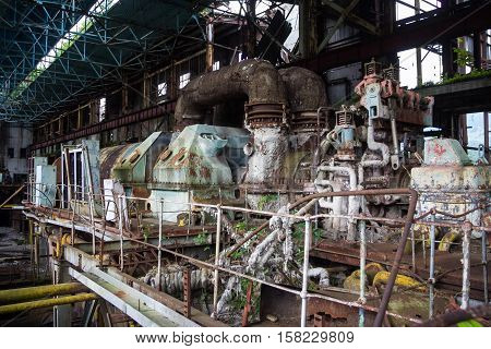 Abandoned, destroyed by war and overgrown machinery of Tkvarcheli power plant, Abkhazia, Georgia