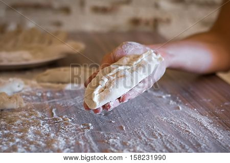 homemade pie dough lays on a female hand