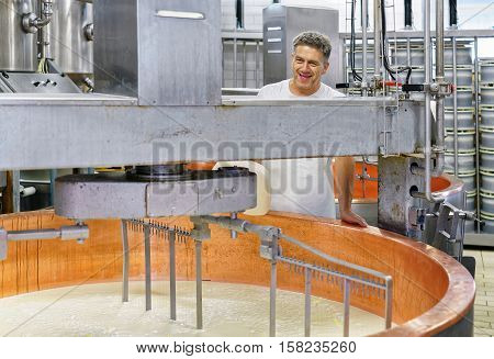 Evillers, France - August 31, 2016: Cheese maker processes Gruyere de Comte Cheese at the dairy in Franche Comte Burgundy of France.
