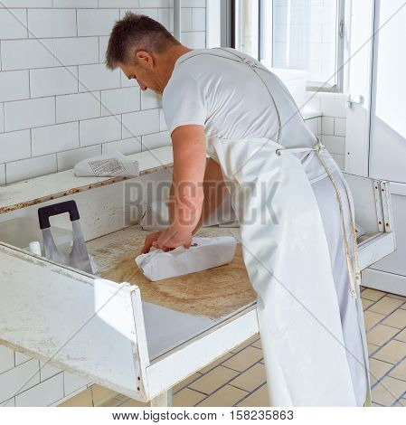 Cheesemaker Wrapping Gruyere De Comte Cheese At The Dairy