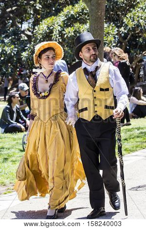 CAGLIARI, ITALY - May 29, 2016: Sunday at La Grande Jatte VIII Ed. At the Public Gardens - Sardinia - couple of young people parading in Victorian costumes