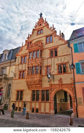 Colmar France - May 1 2012: Maison des Tetes or House of the heads in the Old city center of Colmar Haut Rhin in Alsace France. People on the background