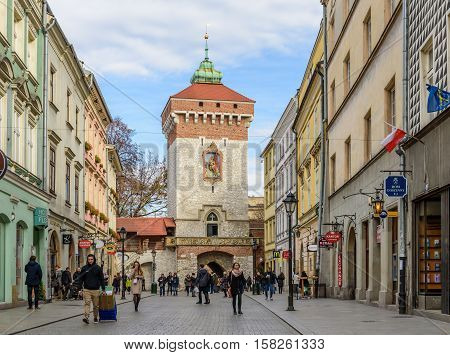 Krakow, Poland - November 5, 2016: Florianska street and Florianska gate, the main pedestrian tourist street in the old town.