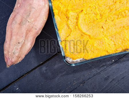 Oven Meal With Sauerkraut And Sweet Potato On Wooden Background