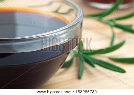 Glass Dish With Soy Sauce And Rosemary Sprigs