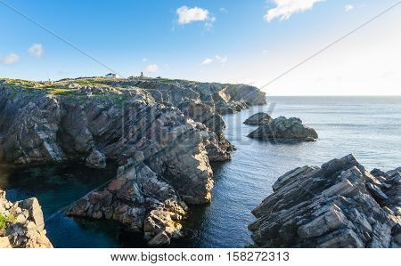 Cape Bona Vista coastline in Newfoundland, Canada.  Lighthouse station atop the end of the cape ahead on the horizon.