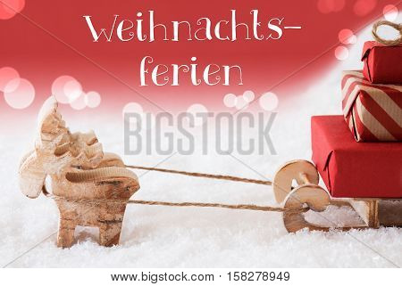 Moose Is Drawing A Sled With Red Gifts Or Presents In Snow. Christmas Card For Seasons Greetings. Red Christmassy Background With Bokeh Effect. German Text Frohe Weihnachten Means Merry Christmas