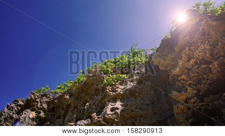 View of the Clift and sun flare with blue sky at the background