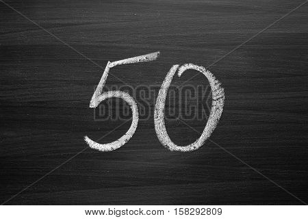 number fifty enumeration written with a chalk on the blackboard
