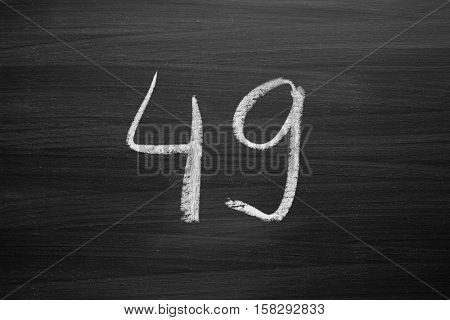 number forty nine enumeration written with a chalk on the blackboard