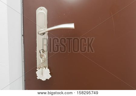 Close Up Of Doorhandle, Key And Door In Home