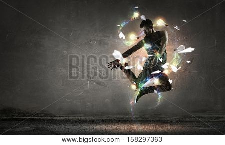 B-boy performing some moves . Mixed media