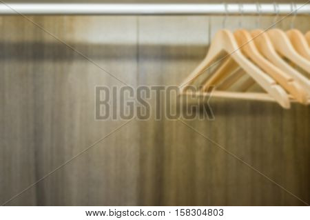 Blurry clothes hanger in wardrobe. Copy space.