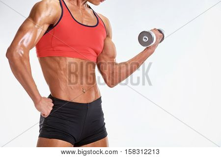 a young and very fit woman training with dumbell with copy space