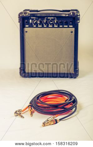 Close-up of guitar amplifier with jack cable.
