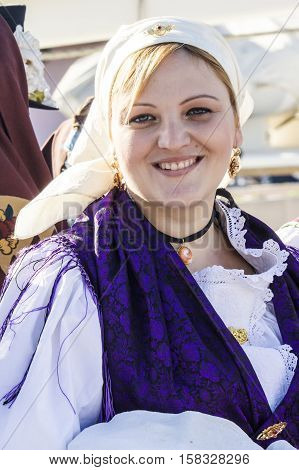CAGLIARI ITALY - October 29 2016: Invitas waterfront Sardinia Port of performances and food traditions. - Portrait of a beautiful girl in the folk group Is massaius de Santu Isidoru - Teulada