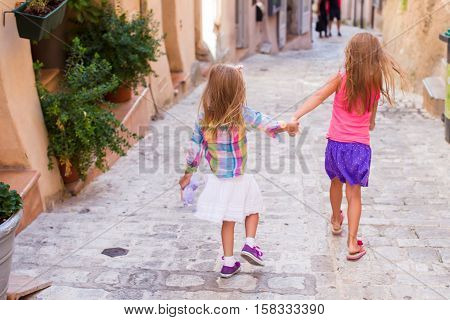 Adorable fashion little girls outdoors in European city