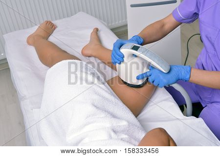 Beauty treatment of a young woman in specialized clinic. Body shaper