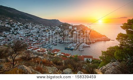 Panoramic views of the marina at Hydra island during sunset Aegean sea, Greece.