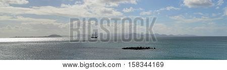 Ocean Panorama Square Rigged Tall Ship with the Northern Coast of Fuerteventura and the Island of Lobos in the Background.