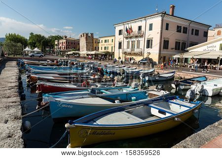 BARDOLINO, ITALY - MAY 4, 2016: Sailboats and fishing boats at Porto di Bardolino harbor on The Garda Lake . Italy