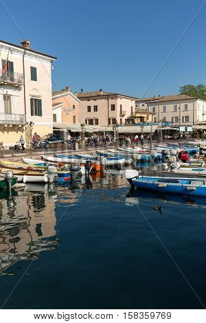 BARDOLINO, ITALY - MAY 4, 2016: Sailboats and fishing boats at Porto di Bardolino harbor on The Garda Lake . Italy
