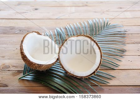coconut and green leaf on wooden background