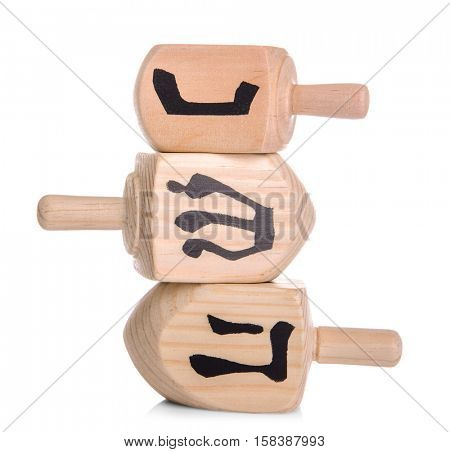 Wooden dreidels for Hanukkah on white background