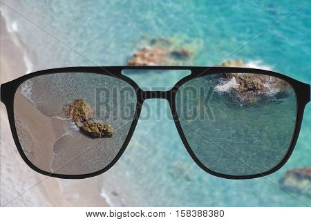 Clear image in sun glasses against blurry land sunny andscape