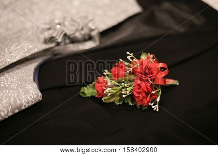 Corsage boutonniere brooch on a man groom suit on wedding day.