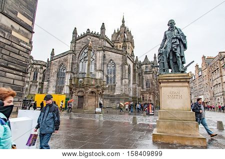 Edinburgh, Scotland, UK- July 18, 2016: The monumento of Adam Smith, The mercat Cross and the Saint Giles' Cathedral on the Royal Mile