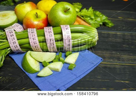 Green vegetables and fruits - celery shoots and apples healthy fitness diet concept