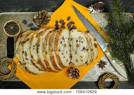 Fresh baked raisins bread sliced on granite board holiday concept
