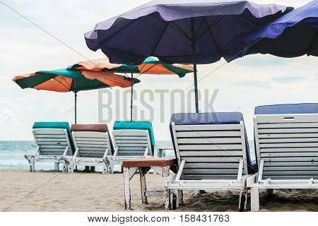 beach chairs and colorful parasols on beach