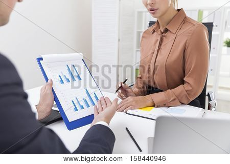 Office Employees Working With A Diagram