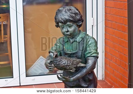 RUSSIA ZELENOGRADSK - OCTOBER 11 2014: Sculpture of a boy with bird in the Zelenogradsk promenade. Zelenogradsk (Cranz) is a resort town in Kaliningrad Oblast Russia near the Curonian Spit on the Baltic Sea.