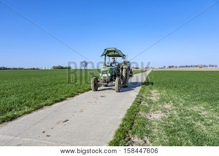 Farmer On His Tractor Rides Back After Plowing His Field